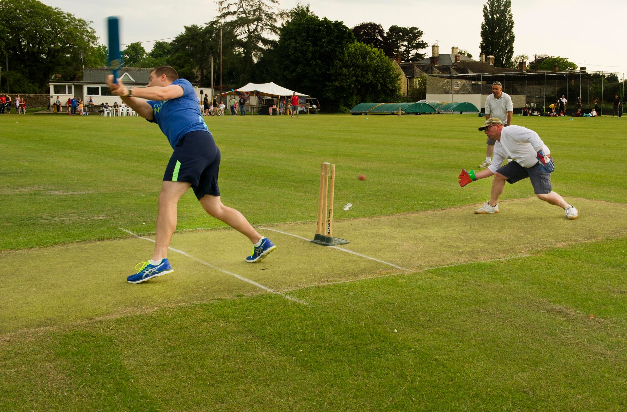 Capt. Matthew Dougherty, 23rd Expeditionary Bomb Squadron pilot, swings to hit a ball at the Fairford Cricket Club, June 8, 2016. The cricket match is an annual event between U.S. service members and locals from the area to learn the sport of cricket and build camaraderie between the community and the base. (U.S. Air Force photo/Senior Airman Sahara L. Fales)