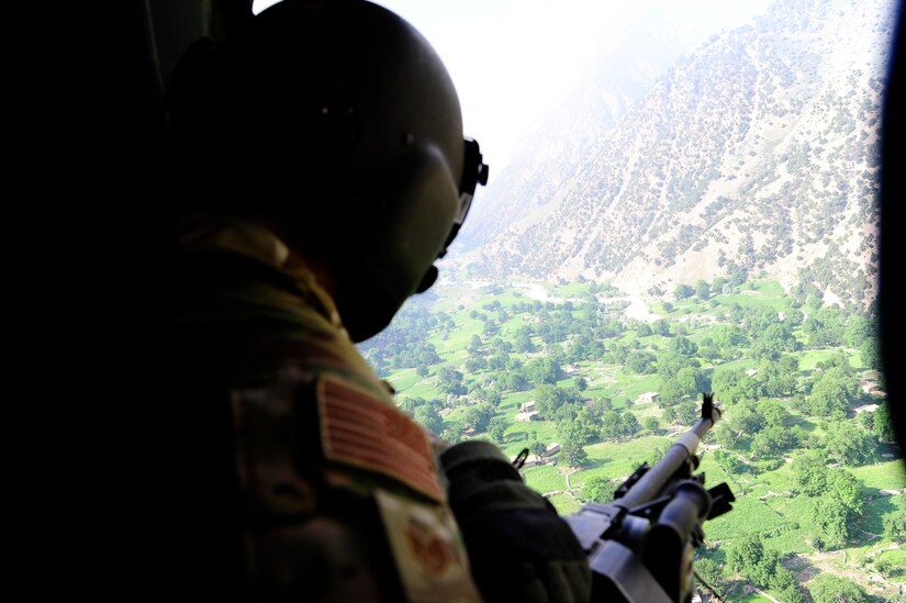 Then Tech. Sgt. Miguel Acevedo, a flight engineer evaluator deployed with the 438th Air Expeditionary Airlift Squadron, scans his sector before a Mi-17 helicopter lands in Barg-e-Matal, an outpost in Nangarhar province, eastern Afghanistan, for a resupply mission July 8, 2012. Acevedo is an Air Force Wounded Warrior and will compete at the Department of Defense 2016 Warrior Games June 16-21, 2016. (U.S. Air Force photo by Staff Sgt. Quinton Russ)