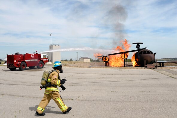 A crash truck battles a fire during training June 9 with reserve Airmen from the 419th Fighter Wing, Hill Air Force Base, Utah. Inside the truck, 17-year-old Joshua Jones, who has a life-threatening illness, had a hands-on experience as a firefighter for a day. While here, Jones and his family toured a fire station, rode in a fire truck, and participated in firefighting training. (U.S. Air Force photo by Todd Cromar) 