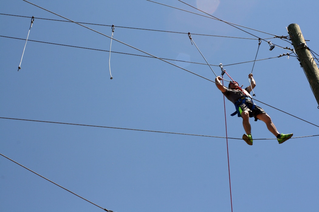 Master Sgt. Mario Reeve, Recruiting and Retention Manager, is one of the first to tackle the Challenge Course, where climbing elements ranged from 15 to 45 feet in the air, during Joint Force Headquarters Wingman Day June 5, 2016 at the National Ability Center in Park City. Other activities included an organization mission brief, tour, and lunch. The group also received a briefing by the National Center for Veterans Studies, a consortium engaged in research, education, outreach, and advocacy to improve the lives of veterans. (U.S. Air National Guard photo by Maj. Jennifer Eaton/Released)