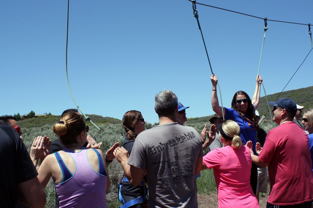 Tech. Sgt. Amanda Erdmann, Utah Air National Guard recruiter, cruises through the practice ropes while fellow Joint Force Headquarters Airmen practice spotting technique during a Wingman Day activity June 5, 2016. JFHQ Wingman Day at the National Ability Center in Park City included an organization mission brief, tour, and instruction on the team building Challenge Course. The group also received a briefing by the National Center for Veterans Studies, a consortium engaged in research, education, outreach, and advocacy to improve the lives of veterans. (U.S. Air National Guard photo by Maj. Jennifer Eaton/Released)