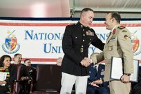 Marine Corps Gen. Joe Dunford, chairman of the Joint Chiefs of Staff, shakes hands with a graduate during the National Defense University's 2016 graduation ceremony at Fort Lesley J. McNair in Washington, D.C., June 9, 2016. The university provides military education to senior leaders of the U.S. armed forces. DoD photo by Army Staff Sgt. Sean K. Harp


