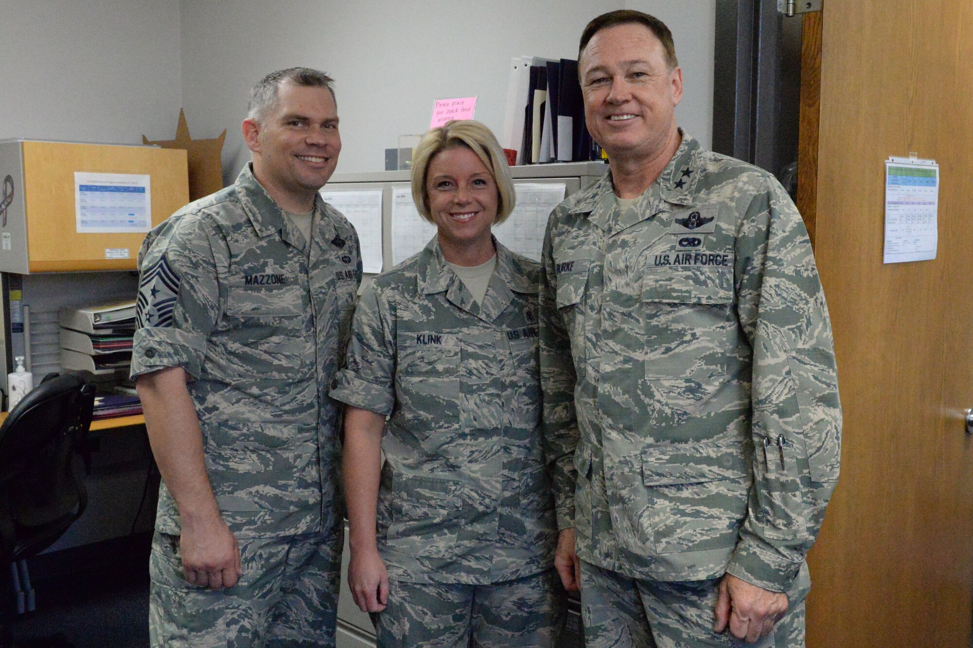 Air Force District of Washington Commander Maj. Gen. Darryl Burke, Air Force District of Washington Command Chief Master Sgt. Tommy Mazzone, and Senior Master Sgt. Jennifer Klink pose for a photo op in the dental clinic on Joint Base Anacostia-Bolling, Washington D.C., June 9, 2016. Klink was recognized by Gen. Burke for her efforts in making 2015 AFDW Annual Awards banquet a memorable event.