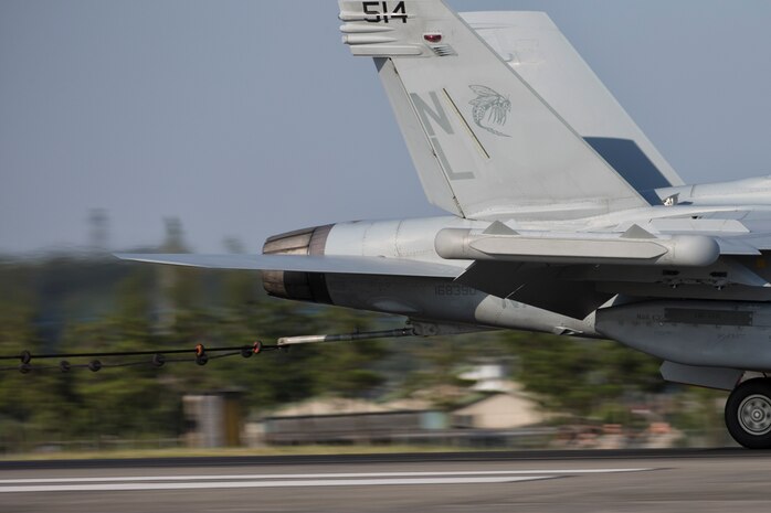 A Navy EA-18G Growler, assigned to the Electronic Attack Squadron (VAQ) 138, engages the aircraft arresting cable at a speed of 150 mph testing the arresting system, June 3, 2016, Yokota Air Base, Japan, during an annual aircraft arresting barrier system test. Testing the system on an annual basis is the responsibility of the 374th Civil Engineer Squadron power productions shop and fire department and 374th Operations Support Squadron airfield management flight. (U.S. Air Force photo by Yasuo Osakabe/Released)