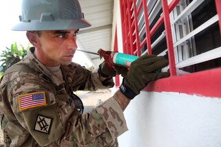 Army Sgt. 1st Class Dickie Valois applies silicon on the exterior of the windows to a new school for Guatemalan children during Beyond the Horizon 2016 in Tocache, Guatemala, June 02, 2016. Valois is assigned to the 1021st Engineer Company. Army photo by Spc. Tamara Cummings