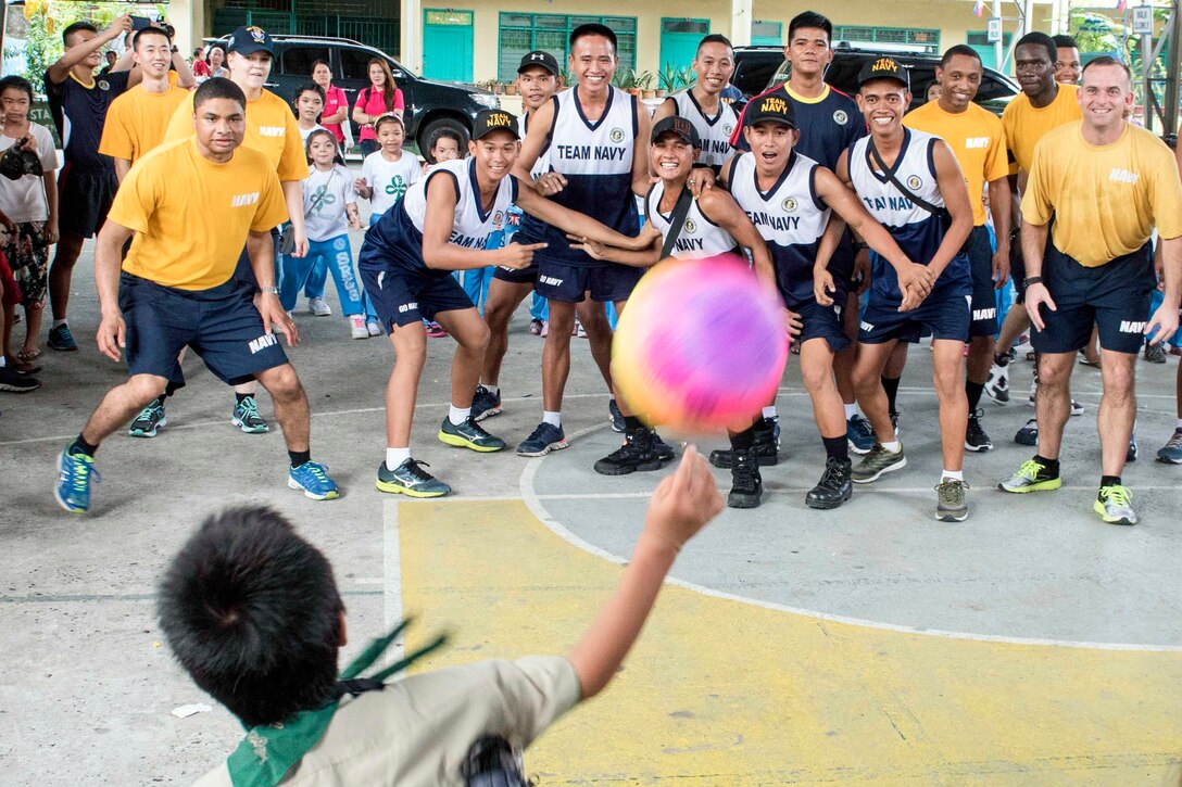 U.S. and Philippine sailors play dodgeball with children at Santa Rita Elementary School in Olongapo City, Philippines, June 9, 2016. Navy photo by Petty Officer 3rd Class Joshua Fulton