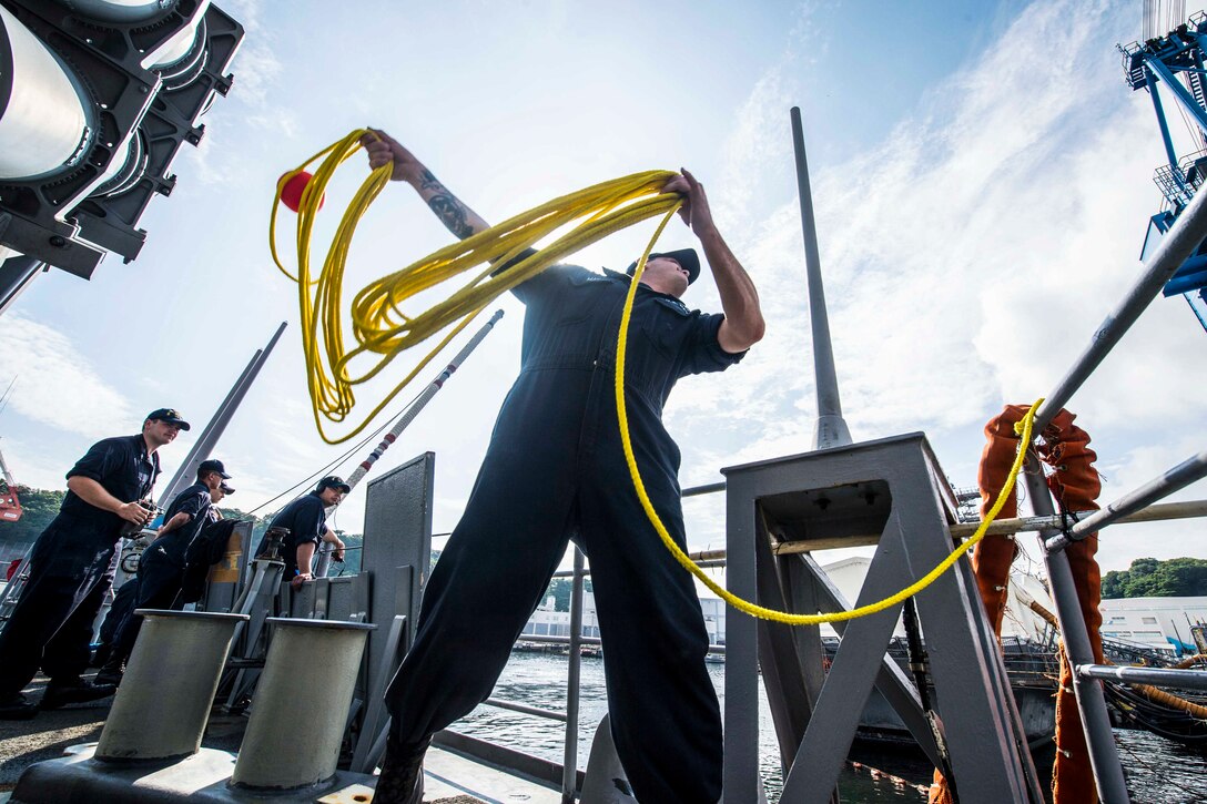 Navy Petty Officer 2nd Class Zakary May throws a mooring line while aboard the USS Chancellorsville in Yokosuka, Japan, June 8, 2016. The Chancellorsville is on patrol with the USS Ronald Reagan Carrier Strike Group in the 7th Fleet area of responsibility supporting security and stability in the Indo-Asia-Pacific region. Navy photo by Petty Officer 2nd Class Andrew Schneider

