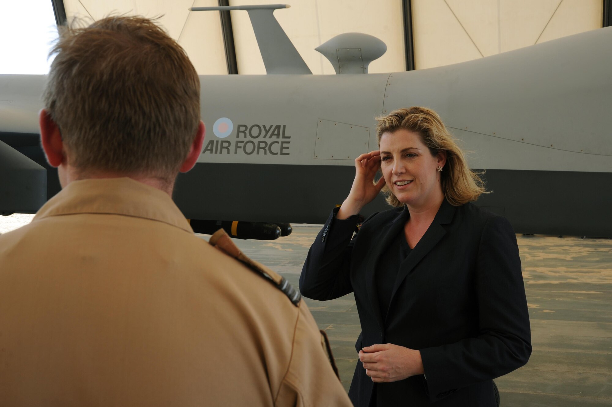 Penny Mordaunt, the U.K Minister of State for the Armed Forces, visits with a member of the U.K. detachment and its MQ-9 Reapers at an undisclosed location in Southwest Asia, June 2, 2016. The visit provided Mordaunt an opportunity to tour various assets in the region and better understand the U.K. military’s working conditions. (U.S. Air Force photo by Senior Airman Zachary Kee)