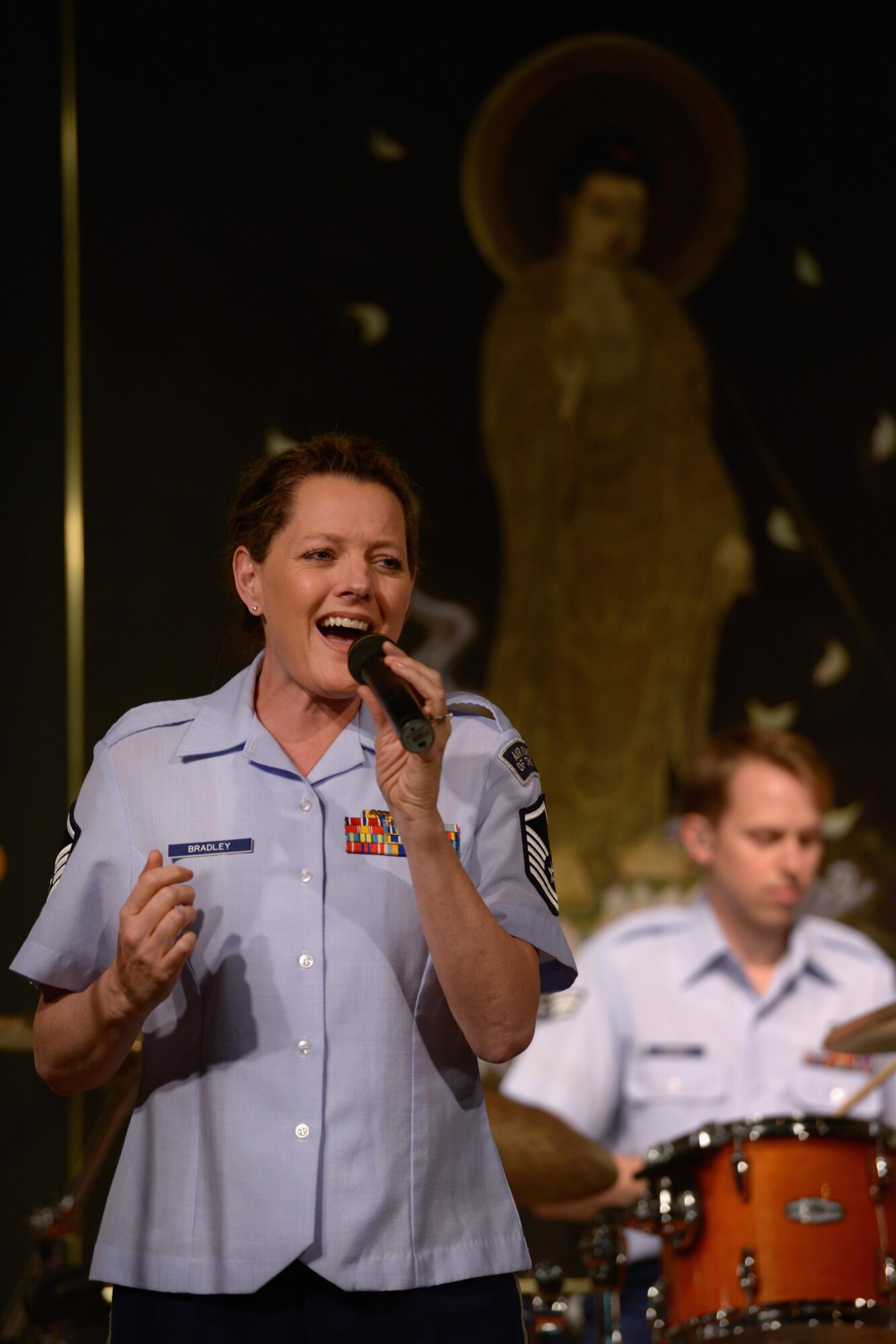 Master Sgt. Julie Bradley, vocalist with the Band of the Pacific-Asia, sings for a crowd during the Tokyo Inaka Festival at Gyokusen Ji Temple, Akiruno City, Tokyo, Japan, June 5, 2016. The Band of the Pacific-Asia performs approximately 200 times each year throughout the Indo-Asia Pacific Region. (U.S. Air Force photo by Staff Sgt. Cody H. Ramirez/Released)