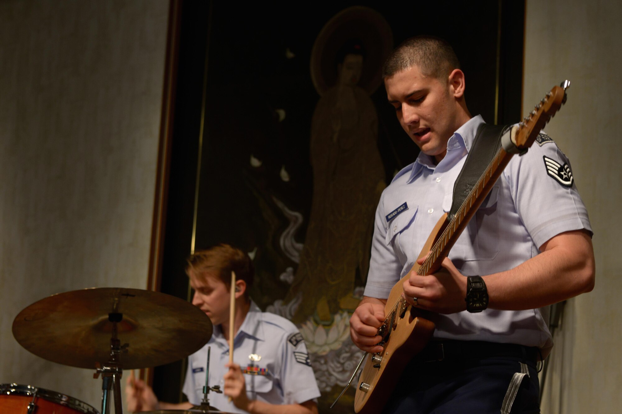 Staff Sgt. Alberto Rosado-Perez, guitarist with the Band of the Pacific-Asia, plays his instrument during the Tokyo Inaka Festival at Gyokusen Ji Temple, Akiruno City, Tokyo, Japan, June 5, 2016. The Band of the Pacific-Asia performs approximately 200 times each year throughout the Indo-Asia Pacific Region. (U.S. Air Force photo by Staff Sgt. Cody H. Ramirez/Released)