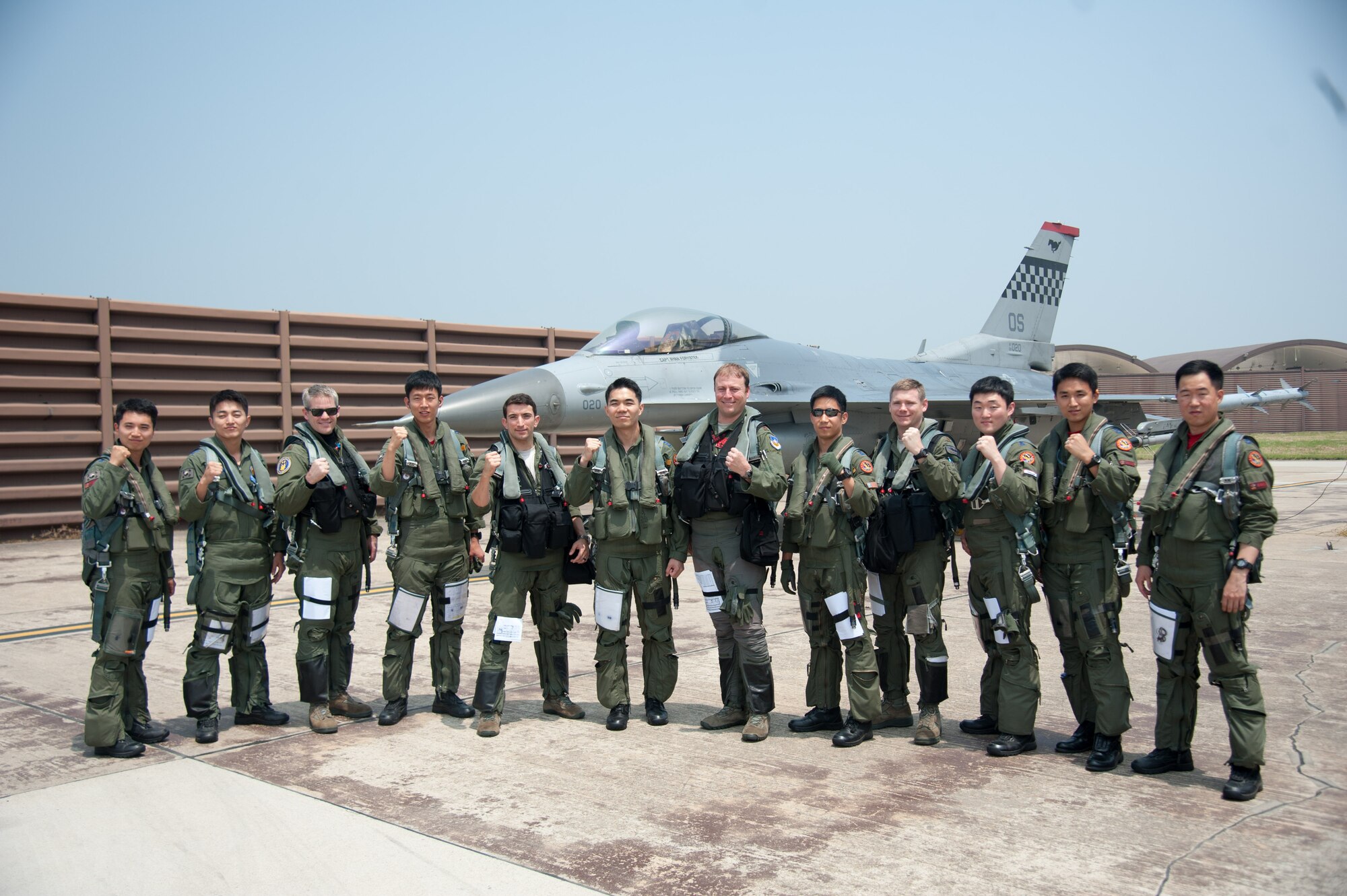 Republic of Korea air force 11th Fighter Wing pilots and U.S. Air Force 36th Fighter Squadron pilots pose for a group photo during Buddy Wing 16-5 at Osan Air Base, Republic of Korea, June 9, 2016. The goal of the Buddy Wing program is to sharpen capabilities between the allied forces so that if need be, they are prepared and ready to fight as a lethal, combined force. (U.S. Air Force photo by Staff Sgt. Jonathan Steffen/Released)