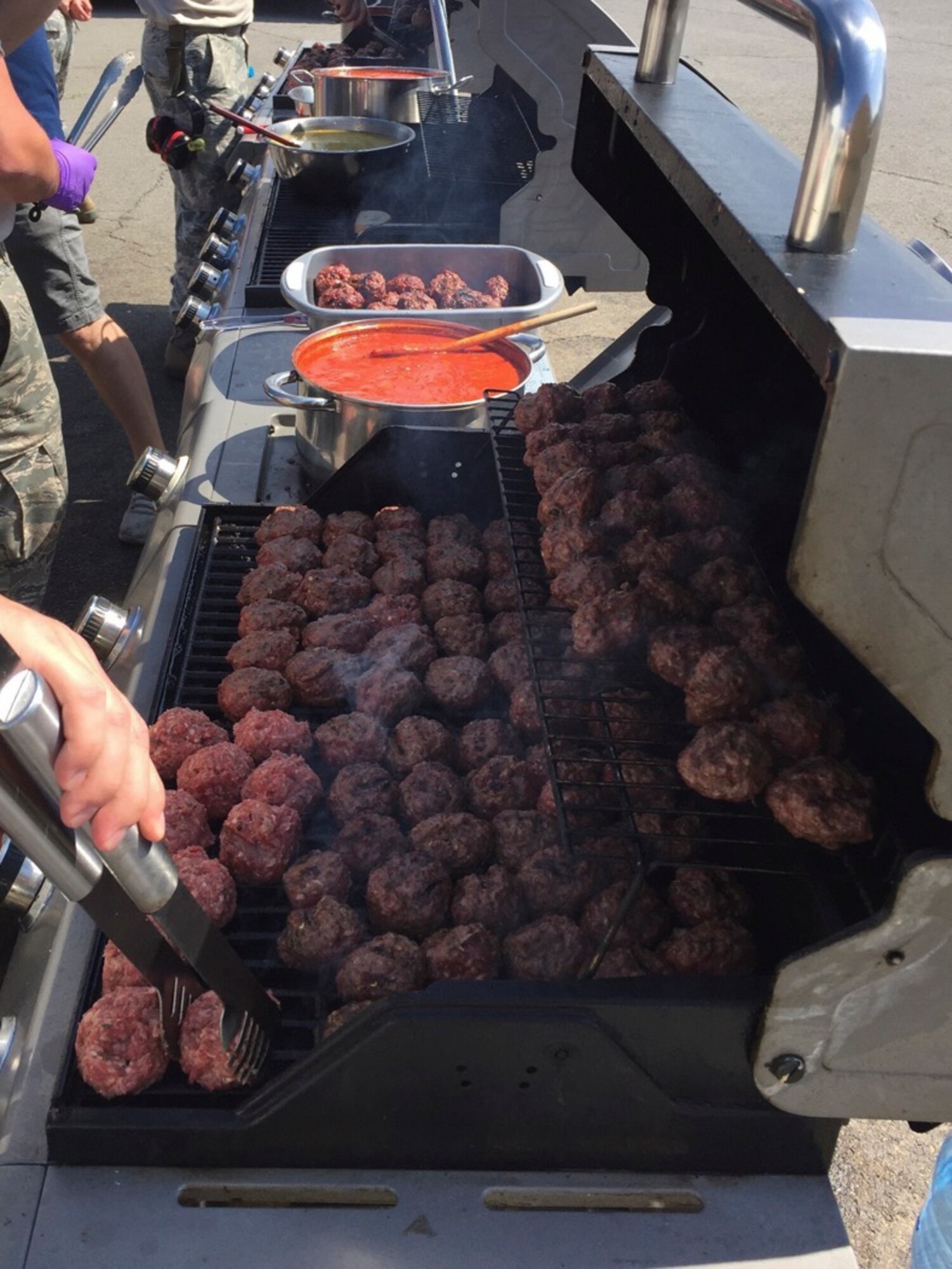 Airmen from 104th Fighter Wing prepare food on the grill during a deployment to Graf Ignatievo, Bulgaria, June 3, 2016. The Airmen are deployed with the 131st Expeditionary Fighter Squadron in support of Operation Atlantic Resolve. (U.S. Air Force Photo by Master Sgt. Adam Casineau/Released)