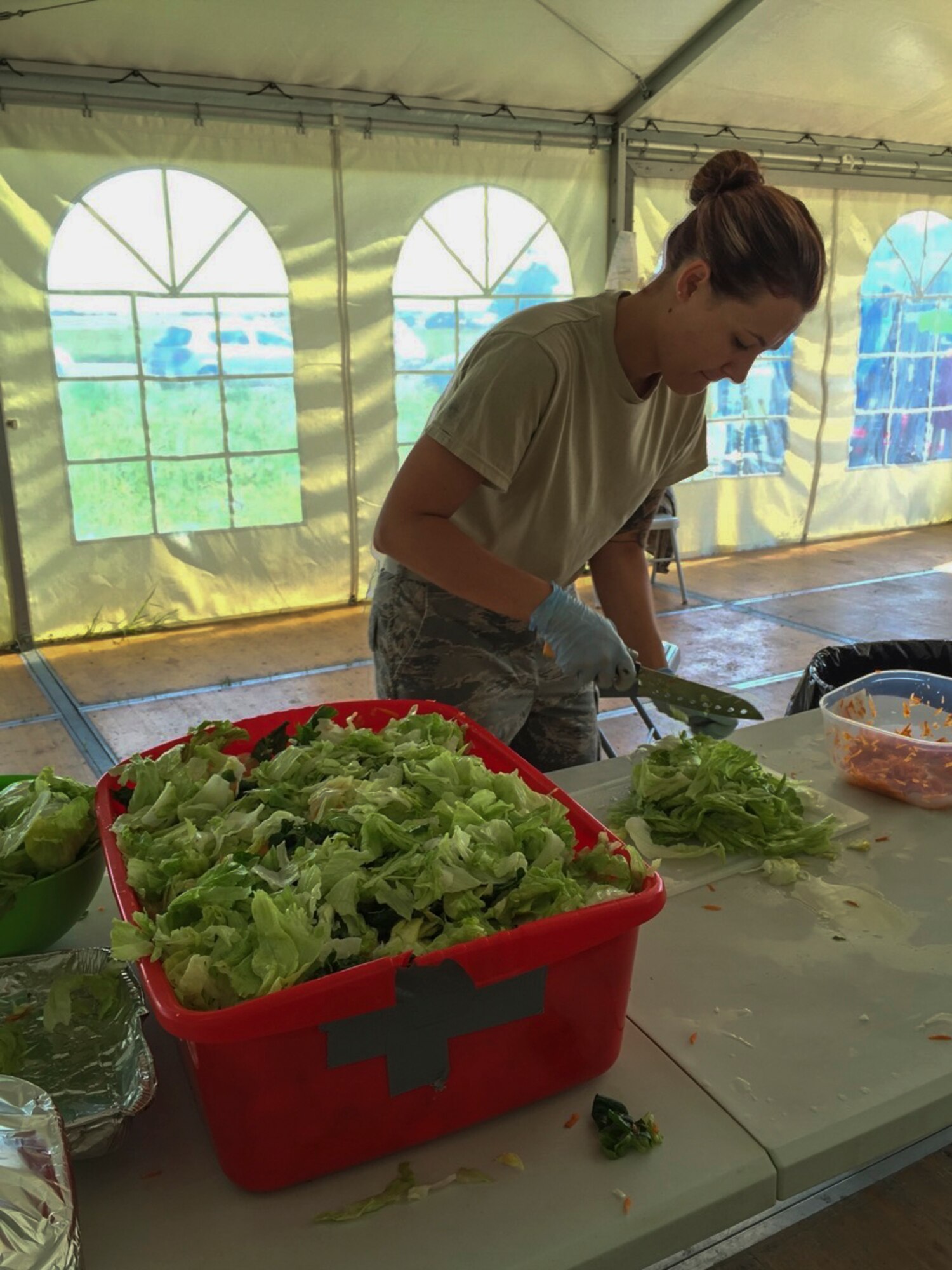 U.S. Air Force Staff Sgt. Krissa Fondakowski, a 104th Fighter Wing member, prepares food as an additional duty in the kitchen tent for Airmen at Graf Ignatievo, Bulgaria, June 3, 2016. Fondakowski is deployed with the 131st Expeditionary Fighter Squadron in support of Operation Atlantic Resolve. (Courtesy Photo by Master Sgt. Adam Casineau/Released)

