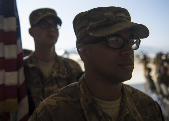Airman 1st Class Christian Higgins, 455th Air Expeditionary Wing honor guard member, stands at parade rest before posting the colors during the 455th AEW change of command ceremony at Bagram Airfield, Afghanistan, June 03, 2016. As a guardsman they demonstrate dedication, commitment and precision, as well as skillful execution of ceremonial drills. (U.S. Air Force photo by Senior Airman Justyn M. Freeman)