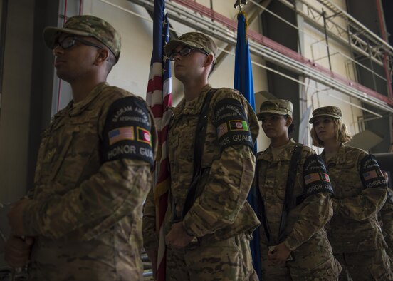 Airman 1st Class Christian Higgins (left), Senior Airman John Roach, Airman 1st Class Bijal Patel, and Staff Sgt. Megan Montagnino, 455th Air Expeditionary Wing Honor Guard, stand at parade rest before posting the colors during the 455th AEW change of command ceremony at Bagram Airfield, Afghanistan, June 03, 2016. The honor guard participated in a demonstration that showcased their training, fitness, teamwork, precision and military bearing. (U.S. Air Force photo by Senior Airman Justyn M. Freeman)