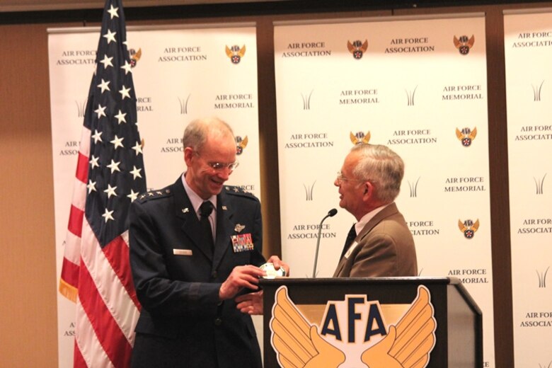 Air Force Surgeon General Lt. Gen. (Dr.) Mark Ediger was the featured speaker at the Air Force Association’s June breakfast. After his presentation, Gen. Ediger was presented with a token of appreciation by retired Air Force Brig. Gen. Bernard Skoch. (U.S. Air Force photo by Prerana Korpe, AFMS Public Affairs)