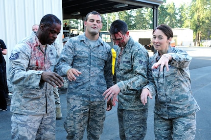 Tech. Sgt. Jermaine Lindsay, Senior Airman Waylen Anderson, Senior Airman Michael Yearsley and Tech. Sgt. Kristal Cavanaugh from the 194th Wing, Washington National Guard, pose as zombies with their simulated injury makeup before a notional earthquake is to strike the Pacific Northwest as part of exercise Cascadia Rising 2016. Cascadia Rising 2016 is a full-scale exercise involving more than 100 federal, state, county and city agencies designed to test the state's earthquake response plan.

