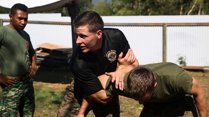 Cpl. Preston G. Thompson demonstrates mechanical advantage control holds during a non-lethal weapons course, June 7, 2016, at Metinaro, Timor Leste, as part of Exercise Crocodilo 16. The course allows Marines to instruct Timorese soldiers on less-than-lethal means to handle future disputes. Crocodilo is a multi-national, bilateral exercise designed to increase interoperability and relations with participating nations. Thompson, from Wyoming, Michigan, is a military policeman and the chief instructor for the non-lethal weapons course with Task Force Koa Moana, originally assigned to Charlie Company, 3rd Law Enforcement Battalion, III Marine Expeditionary Force.