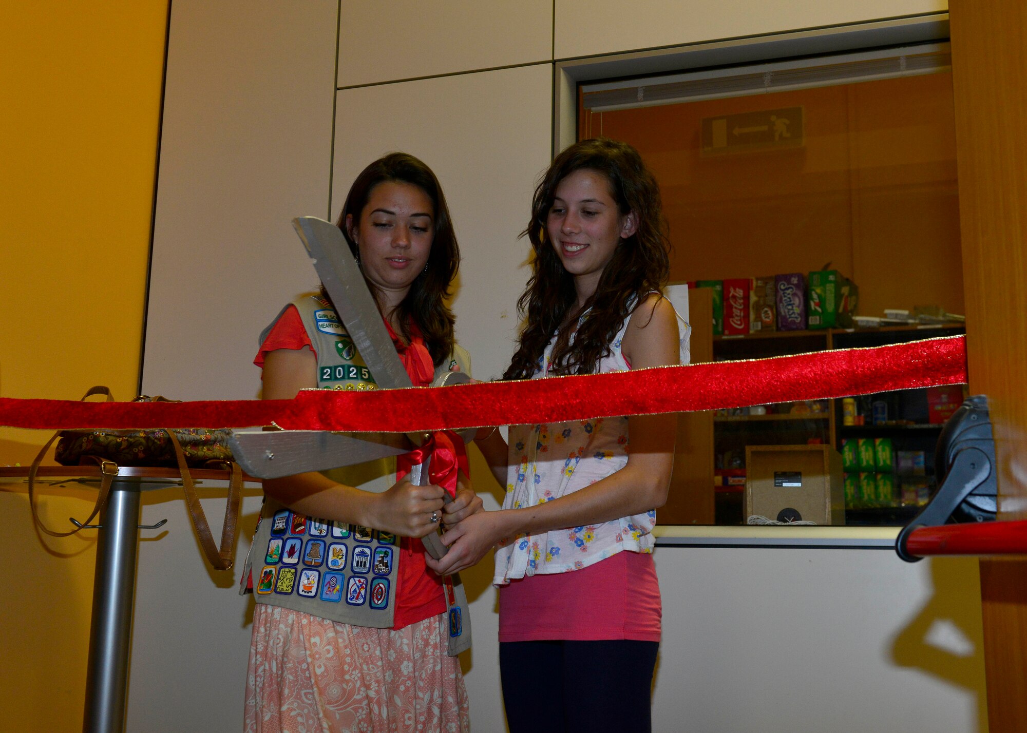 Marie and Sonia Seguin cut the ribbon during the Refuge’s relaxation room unveiling, June 8, 2016, at Aviano Air base, Italy. The room offers a quiet space for Team Aviano members to rest, recover and recharge. (U.S. photo by Airman 1st Class Cary Smith/Released)