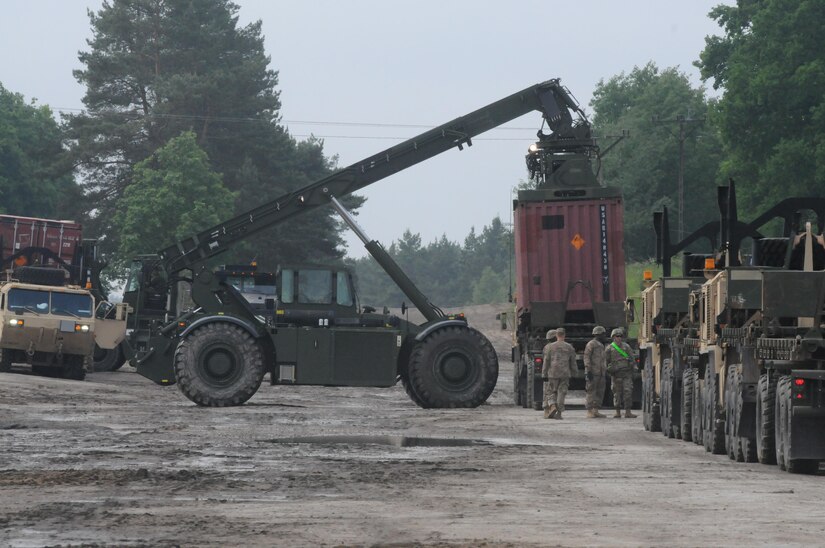 An all terrain Retch downloads one of many containers loaded with ordnance at the Ammo Supply Point for the 592nd Ordnance Co. at Drawsko Pomorskie