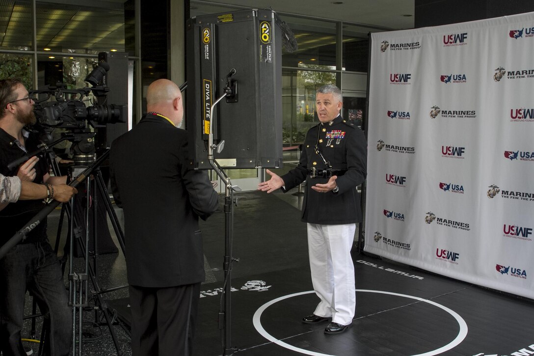 Brigadier Gen. Paul Kennedy answers a question from a U.S. Wrestling Foundation representative at the U.S. Wrestling Foundation Gala in Los Angeles, June 9, 2016. The Marine Corps joined a host of VIPs in in sending off Team USA as they compete in the World Cup, their last competition before the Olympic Games in Rio de Janeiro and awarded two young future leaders at the gala. Marine recruiters view combat sports (professional and amateur wrestling and mixed martial arts) as excellent programming venues to reach a large portion of the Marine Corps’ enlisted and officer recruiting prospects. Principles taught to student wrestlers such as discipline, physical fitness, aggressive attitude and mental and physical toughness align with Marine Corps principles.