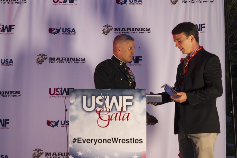 Brigadier Gen. Paul Kennedy presents Ryan Partridge the Excellence in Leadership Award during the U.S. Wrestling Foundation Gala in Los Angeles, June 9, 2016. The Marine Corps advocates for high-achieving student athletes and views this engagement as an opportunity to establish a strong connection with America’s youth. Partridge, a Vienna, Va., native and Madison High School senior, is a multi-sport athlete (football, wrestling, and lacrosse), a member of National Honor Society, and also founder of the “Early Birds Powerlifting Club” at Madison High. Partridge plans to attend the University of Virginia and become a member of the NROTC program there. Kennedy currently serves as the commanding general of Marine Corps Recruiting Command.