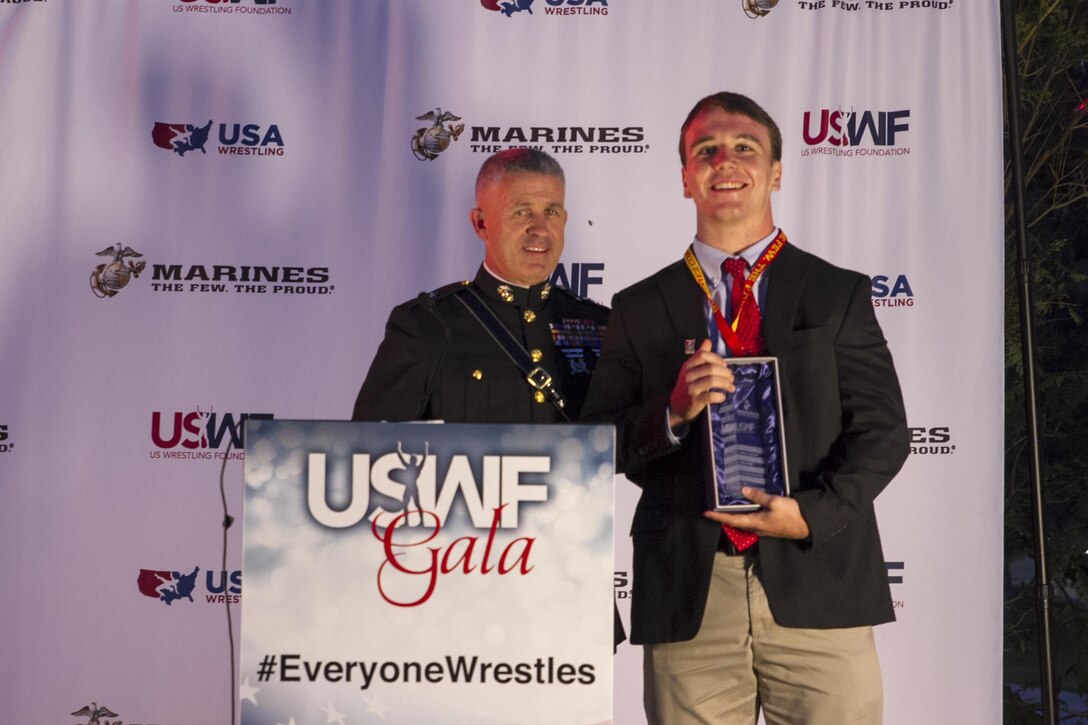 Brigadier Gen. Paul Kennedy presents Ryan Partridge the Excellence in Leadership Award during the U.S. Wrestling Foundation Gala in Los Angeles, June 9, 2016. The Marine Corps advocates for high-achieving student athletes and views this engagement as an opportunity to establish a strong connection with America’s youth. Partridge, a Vienna, Va., native and Madison High School senior, is a multi-sport athlete (football, wrestling, and lacrosse), a member of National Honor Society, and also founder of the “Early Birds Powerlifting Club” at Madison High. Partridge plans to attend the University of Virginia and become a member of the NROTC program there. Kennedy currently serves as the commanding general of Marine Corps Recruiting Command.