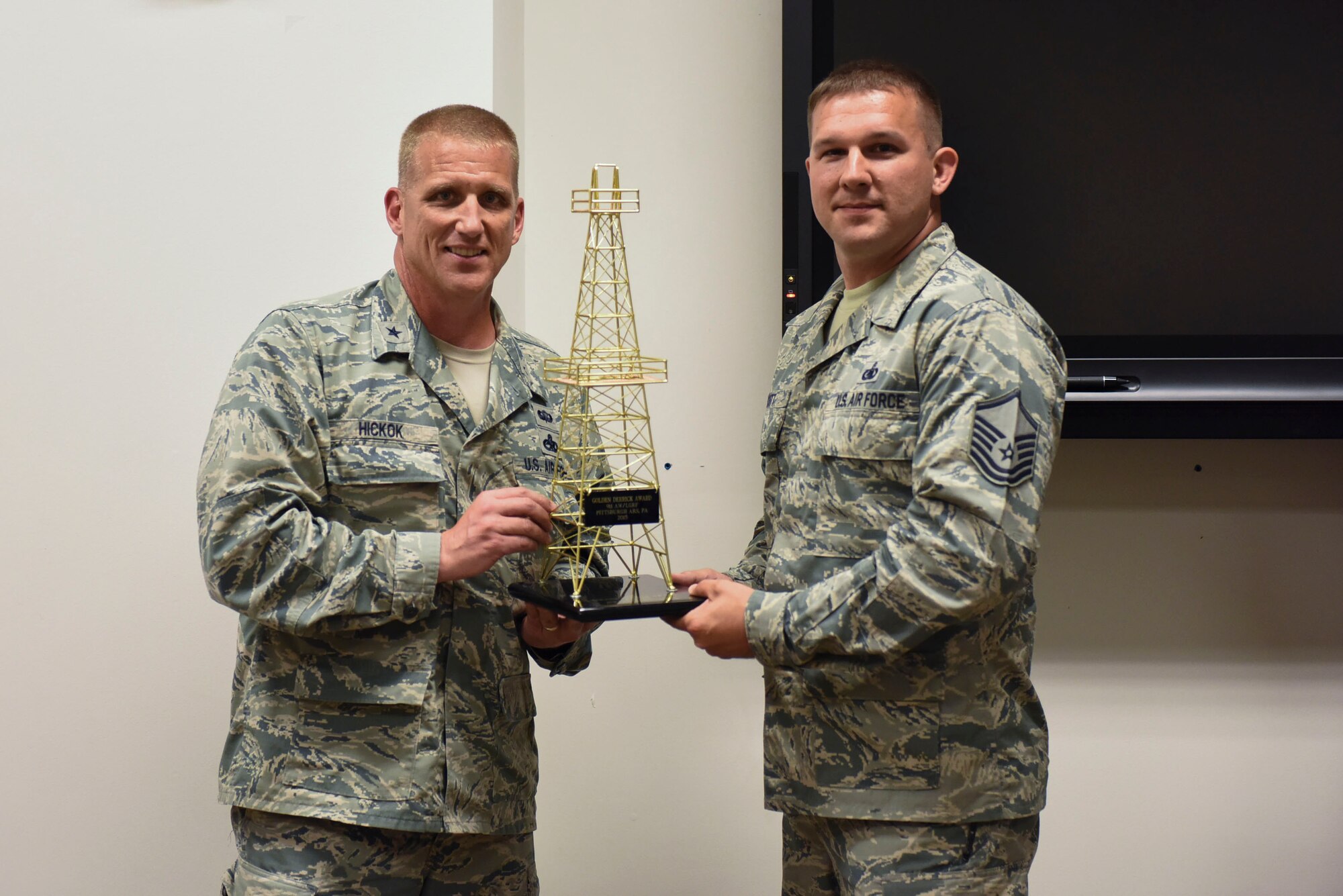 Brig. Gen. John A. Hickok, deputy director of logistics, engineering and force protection at Headquarters Air Force Reserve Command, presents the Golden Derrick Award to Master Sgt. Ryan Scott, superintendent of the 911th Logistic Readiness Squadron Fuels Flight at the Pittsburgh International Airport Air Reserve Station, June 5, 2016. Scott received the award on behalf of the fuels flight. (U.S. Air Force photo by Airman Beth Kobily)