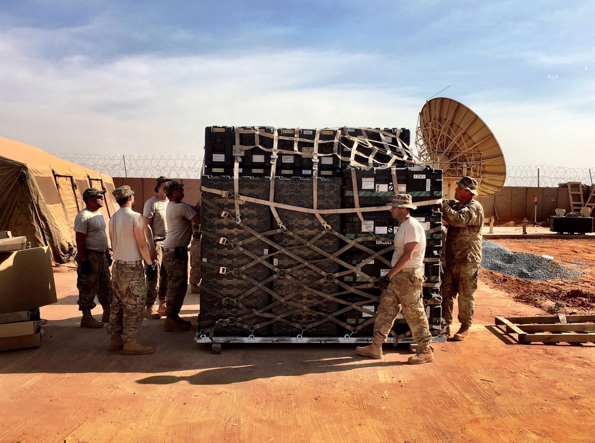 Airmen from the 1st Combat Communications Squadron prepare equipment in Africa. The Airmen replaced pallets of communications equipment for transportation as another squadron replaced the first. This was the first time an entire combat communications team and equipment were switched out. (Courtesy Photo) 