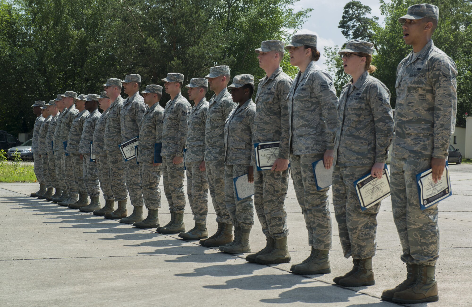 Graduates from the Air Education and Training Command’s Class 5 Basic Protocol, Honors and Ceremonies Course recite the Honor Guard Creed after receiving their diplomas June 9, 2016, at Ramstein Air Base, Germany. Members of the Air Force Honor Guard Mobile Training Team taught the course for Honor Guard Airmen across U.S. Air Forces in Europe. The graduates completed 80 hours of training in pallbearing, firing party, colors and maintenance and wear of the ceremonial uniform. (U.S. Air Force photo/Airman 1st Class Tryphena Mayhugh)