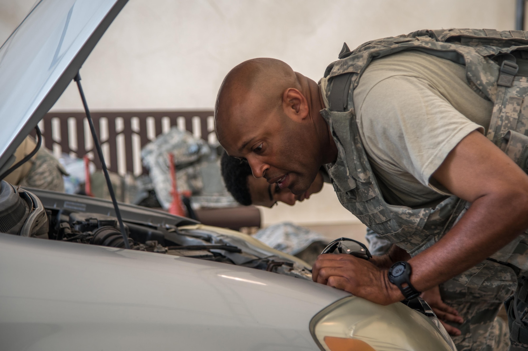 Tech. Sgt. Kevin Foster, 403rd Security Forces Squadron squad leader, searches a vehicle for improvised explosive devices during training at Keesler Air Force Base, Mississippi June 6, 2016. The hands-on training focused on identifying IEDs, setting up ECPs, and securely searching vehicles. (U.S. Air Force photo by Staff Sgt. Shelton Sherrill) 