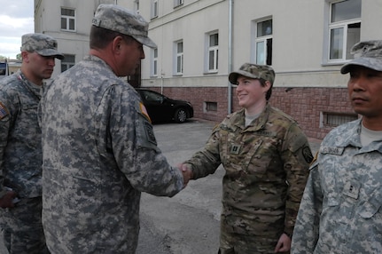 Capt. Rebecca Deal, with the 16th Sustainment Brigade, is presented with a commander's coin from Command Sgt. Maj. Thomas P. Brashears, the command sergeant major with the 364th Expeditionary Sustainment Command, for her exceptional contribution to Anakonda 2016 in Warsaw, Poland, June 6, 2016. Anakonda 2016 is one of U.S. Army Europe's premier multinational training events, which features 24 nations and seeks to train, exercise and integrate Polish national command and force structures into an allied, joint, multinational environment.