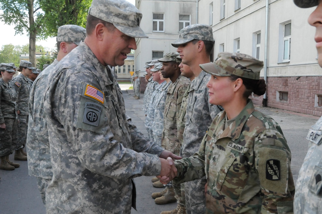 Sgt. Redd, with B Company 324th Signal Company, is presented with a commander's coin from Command Sgt. Maj. Thomas P. Brashears, the command sergeant major with the 364th Expeditionary Sustainment Command, for her exceptional contribution to Anakonda 2016 in Warsaw, Poland, June 6, 2016. Anakonda 2016 is one of U.S. Army Europe's premier multinational training events, which features 24 nations and seeks to train, exercise and integrate Polish national command and force structures into an allied, joint, multinational environment.