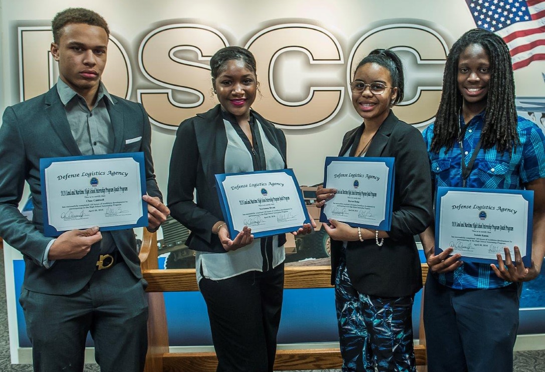 (l-r): Chaz Caldwell, Terrionna Bryan, Rayven Hodge and Isaiah Eaton display their diplomas after graduating from the DLA Land and Maritime High School Internship Program. 