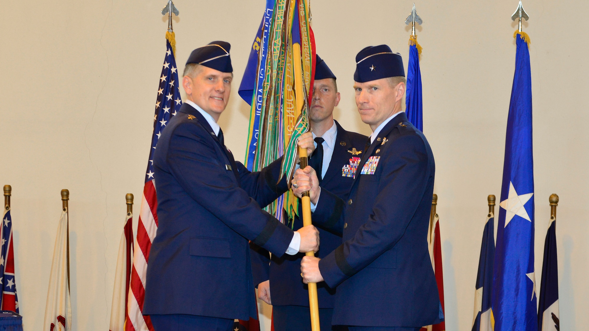 Lt. Gen. Timothy Ray, 3rd Air Force commander, passes the 31st Fighter Wing guidon to Brig. Gen. Lance Landrum during the 31st FW change of command ceremony, June 10, 2016, at Aviano Air Base, Italy. During the ceremony, Landrum became the 14th commander to take command of the 31st FW since it relocated to Aviano, Italy, from Homestead, Fla. (U.S. Air Force photo by Airman 1st Class Cary Smith/Released)