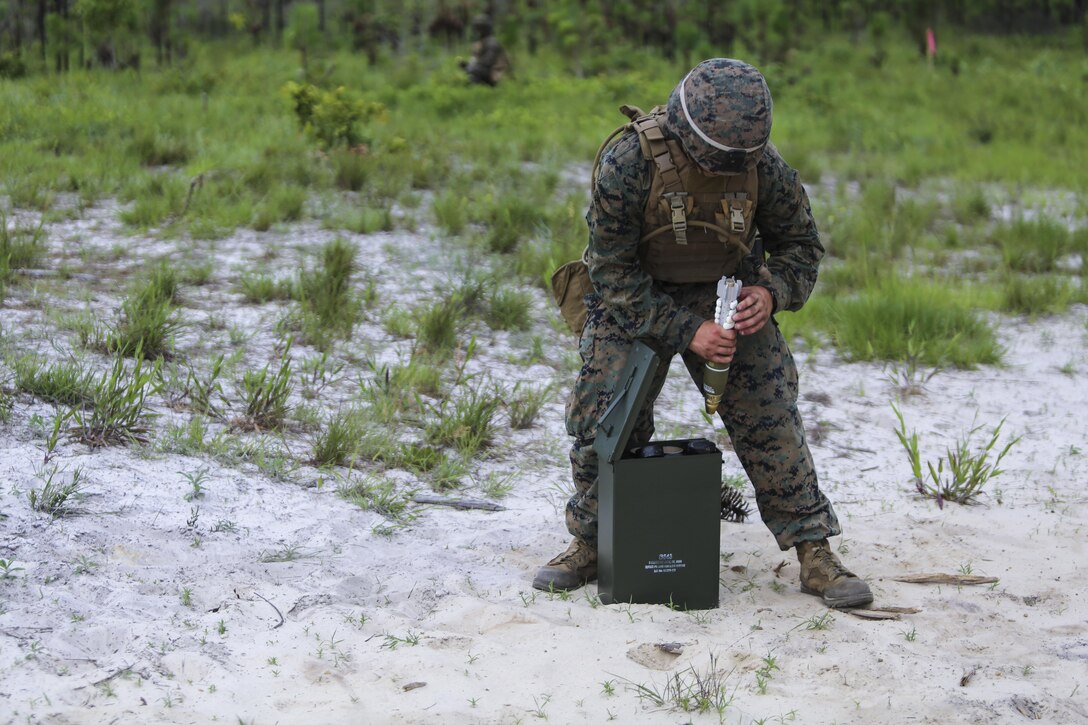A mortarman with 1st Battalion, 2nd Marine Regiment, 2nd Marine Division, primes a mortar round before handing it off to a gunner for firing at Camp Lejeune, N.C., June 6, 2016. Marines underwent mortar familiarization and proficiency training in preparation for their upcoming deployment in support of Special-Purpose Marine Air-Ground Task Force. (U.S. Marine Corps photo by Lance Cpl. Aaron K. Fiala/Released)