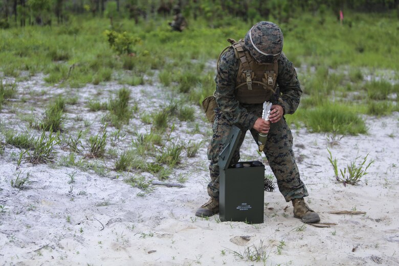 A mortarman with 1st Battalion, 2nd Marine Regiment, 2nd Marine Division, primes a mortar round before handing it off to a gunner for firing at Camp Lejeune, N.C., June 6, 2016. Marines underwent mortar familiarization and proficiency training in preparation for their upcoming deployment in support of Special-Purpose Marine Air-Ground Task Force. (U.S. Marine Corps photo by Lance Cpl. Aaron K. Fiala/Released)