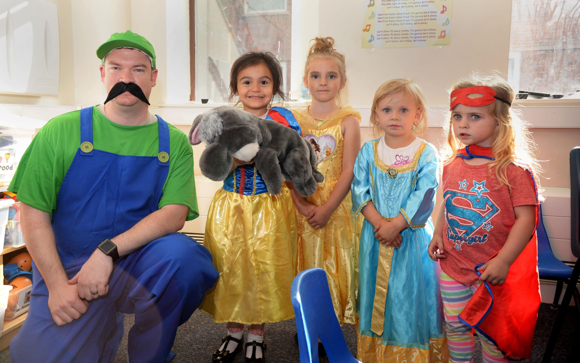 U.S. Air Force Tech. Sgt. Luther Rippy, left, 352nd Special Operations Maintenance Squadron assistant weapons chief, poses with kids dressed up during the “Hearts Apart” event at the base chapel June 9, 2016, on RAF Mildenhall, England. This month’s theme was “Cartoon.” (U.S. Air Force photo by Airman 1st Class Tenley Long/Released)