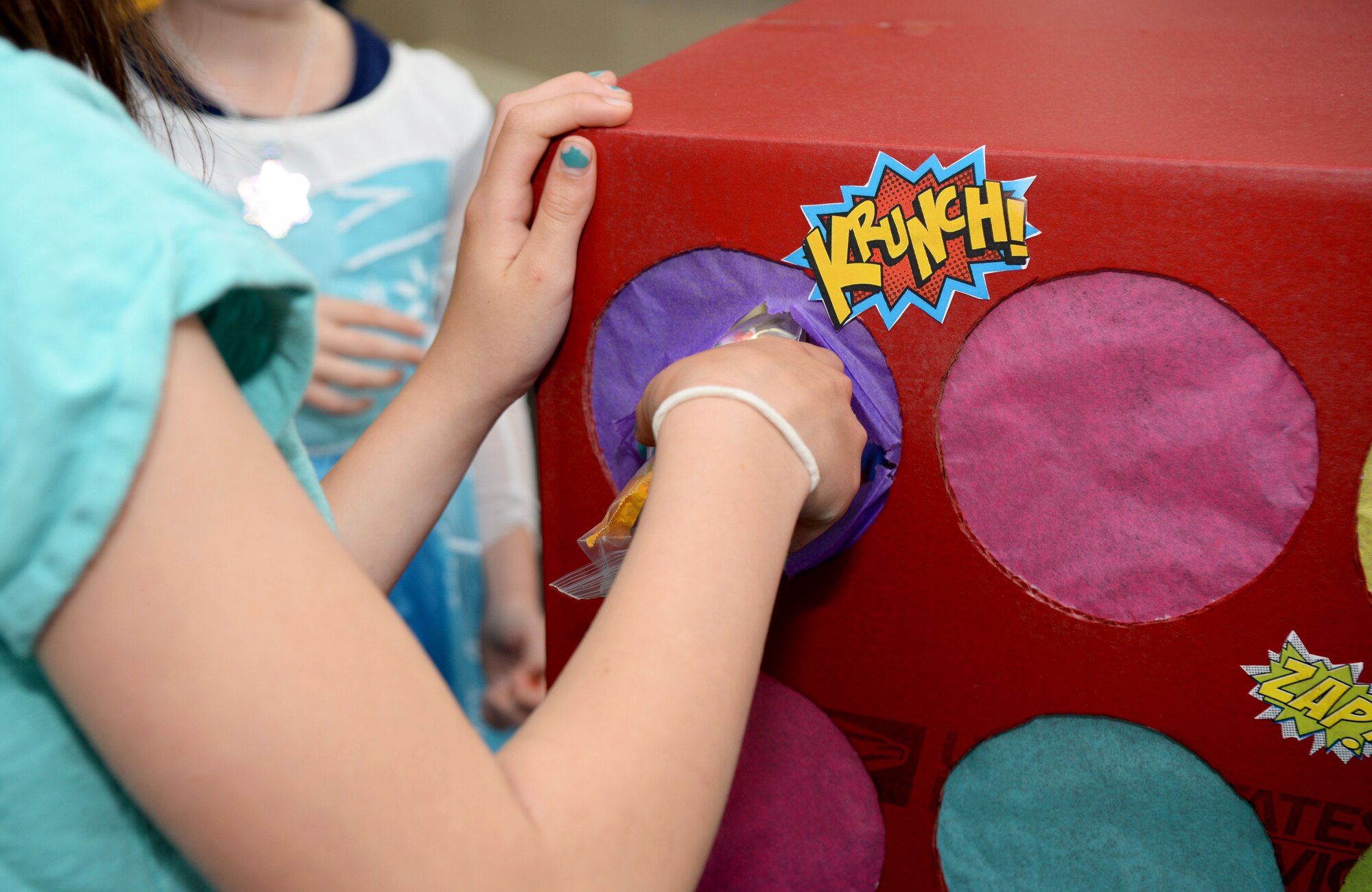 Kids punch into the “Candy Box Punch” at the “Hearts Apart” event at the base chapel June 9, 2016, on RAF Mildenhall, England. This was just one of many highlights the 352nd Special Operations Maintenance Squadron put together for the event. (U.S. Air Force photo by Airman 1st Class Tenley Long/Released)