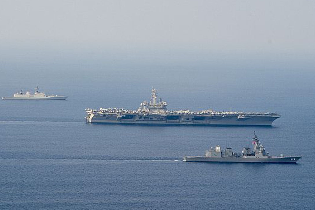 The aircraft carrier USS Theodore Roosevelt, Japanese Maritime Self-Defense destroyer Fuyuzuki and Indian Shivalik-class frigate Shivalik transit into formation during a photo exercise as a part of Exercise Malabar 2015. U.S. Navy photo by Mass Communication Specialist 2nd Class Chris Brown