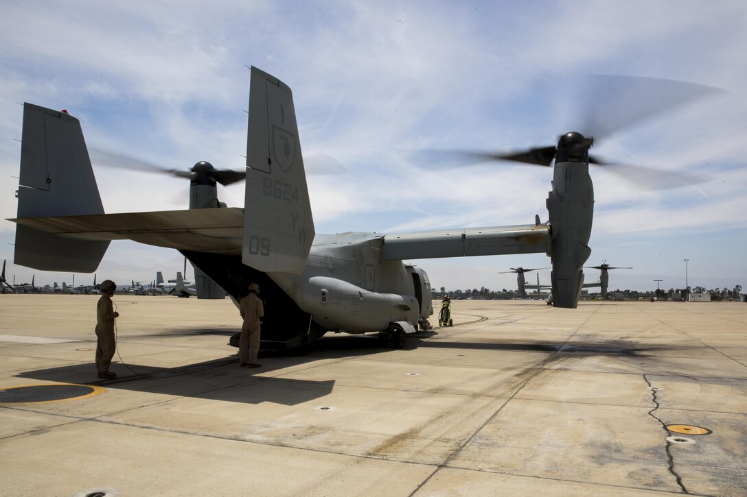 Marines with Marine Medium Tiltrotor Squadron (VMM) 165 prepare an MV-22B Osprey for a training flight aboard Marine Corps Air Station Miramar, Calif., June 8. The training consisted of confined area landings (CALs) and reduced visibility landings (RVLs). (U.S. Marine Corps photo by Sgt. Michael Thorn/Released)