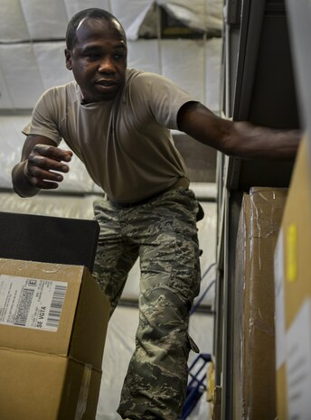 Staff Sgt. Wendell Belford, 99th Logistics Readiness
Squadron F-35 Aircraft Parts Store supervisor, reaches for
a box while preparing to move parts from the old to the
new location, at Nellis Air Force Base, Nev., June 6. The
amenities that the new facility provides will allow the
Airmen of the F-35 parts shop to accomplish their missions,
and with the growth of the F-35 program increasing in size
the 99th LRS had to follow suit. (U.S. Air Force photo by Airman 1st Class Kevin Tanenbaum)