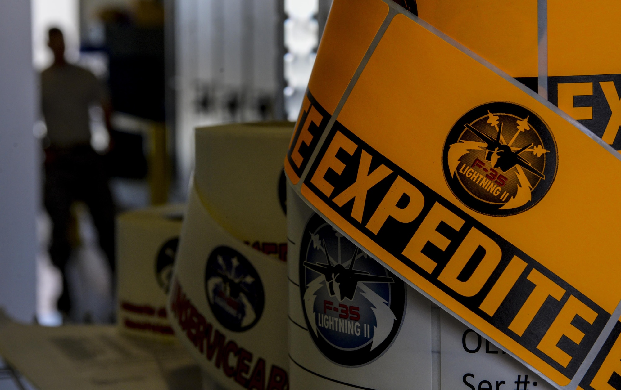 A roll of expidite stickers sit on a shelve as the Airmen from the 99th Logistics Readiness Squadron F-35 Aircraft Parts Store move parts to their new location at Nellis Air Force Base, Nev., June 6. In accomplishing their mission, the F-35 parts store works in close conjunction with Lockheed Martin
to ensure that the system and process run as smooth as possible. (U.S. Air Force photo by Airman 1st Class Kevin Tanenbaum)