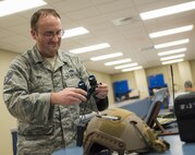 Staff Sgt. Joshua Rix, 919th Special Operations Support Squadron, performs a check on a set of night-vision-goggles prior to mounting them onto a helmet at Duke Field, Fla.  The Airmen in the Aircrew Flight Equipment section of 919th SOSS ensure all flight gear and training is current and up to date for the wing’s flying personnel.  (U.S. Air Force photo/Tech. Sgt. Sam King)  