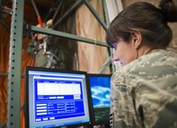 Staff Sgt. Autumn Rouke, 919th Special Operations Support Squadron, monitors the progress of a parachute landing simulator test for an aircrew member at Duke Field Fla.  The Airmen in the Aircrew Flight Equipment section of 919th SOSS ensure all flight gear and training is current and up to date for the wing’s flying personnel.  (U.S. Air Force photo/Tech. Sgt. Sam King)