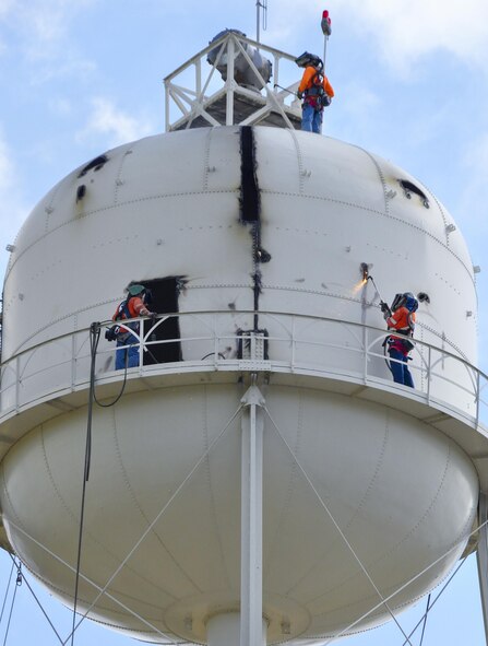 Construction crew members cut into pieces of the former water tower at Duke Field, Fla. During demolition work, crews found a nameplate attached that indicated the 70,000-gallon water tank was originally erected in 1942, predating the passing of the base's namesake, 1st Lt. Robert L. Duke, who was killed the following year.  (U.S. Air Force photo/Dan Neely)  