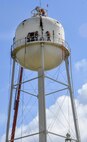 Construction crew members cut into pieces of a former water tower at Duke Field, Fla. During demolition work, crews found a nameplate attached that indicated the 70,000-gallon water tank was originally erected in 1942, predating the passing of the base's namesake, 1st Lt. Robert L. Duke, who was killed the following year.  (U.S. Air Force photo/Dan Neely)  