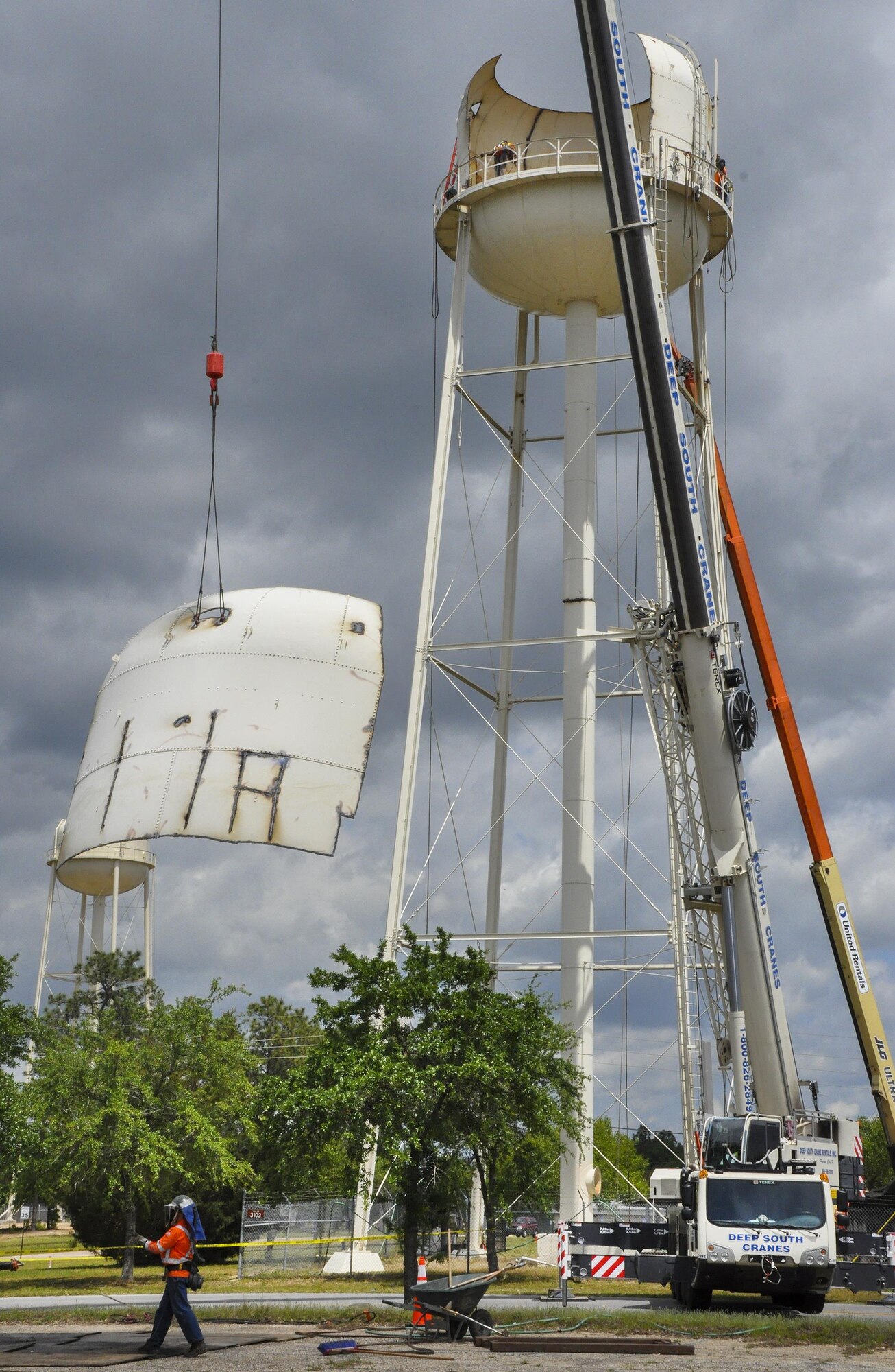 Construction crew members bring down a panel of the former water tower at Duke Field, Fla. During demolition work, crews found a nameplate attached that indicated the 70,000-gallon water tank was originally erected in 1942, predating the passing of the base's namesake, 1st Lt. Robert L. Duke, who was killed the following year.  (U.S. Air Force photo/Dan Neely)  