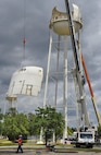 Construction crew members bring down a panel of the former water tower at Duke Field, Fla. During demolition work, crews found a nameplate attached that indicated the 70,000-gallon water tank was originally erected in 1942, predating the passing of the base's namesake, 1st Lt. Robert L. Duke, who was killed the following year.  (U.S. Air Force photo/Dan Neely)  