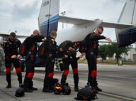 An Army Black Dagger parachute team prepares prior to a jump May 17 at Duke Field, Fla.  They jumped out of a C-145 Skytruck, stationed exclusively at Duke Field.  The team is composed of volunteers from throughout the Army special operations community. Their mission is to perform live aerial demonstrations in support of Army special operations community relations and recruiting.  (U.S. Air Force photo/Dan Neely) 